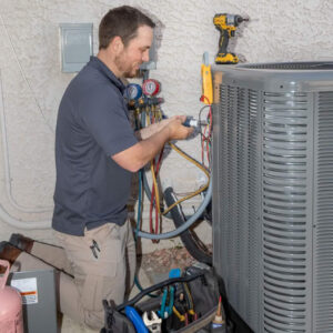 hvac tech repairing heat pump